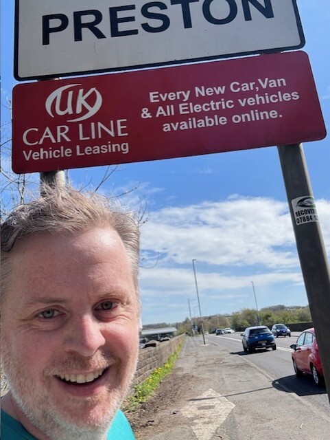 Martin Gate at the UK Carline Tickled Trout entrance sign in Preston