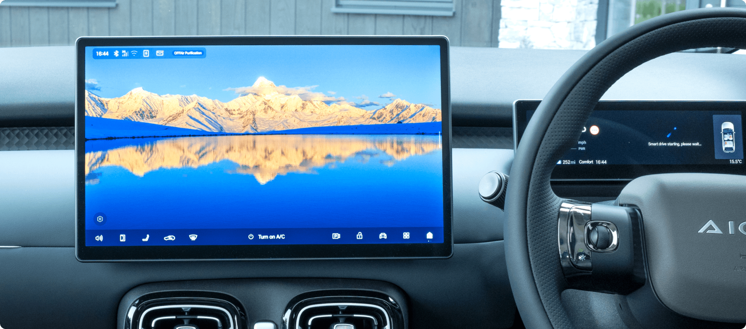 AION UT dashboard with a wide central touchscreen, digital driver display and right-hand-drive steering wheel