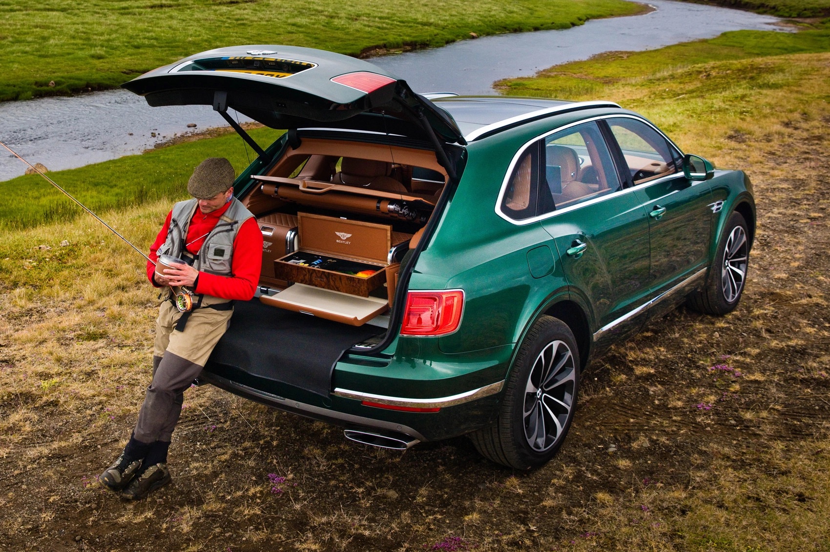 Green Bentley Bentayga with its boot open to reveal the Mulliner fly-fishing equipment